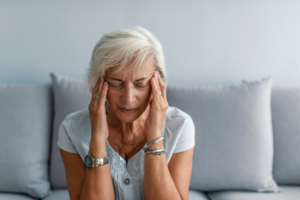 Photo of woman with migraine. Understanding Migraines in Women: Hormonal Triggers and Managing Attacks