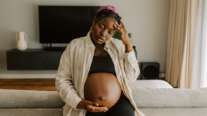 Young pregnant woman experiencing migraine