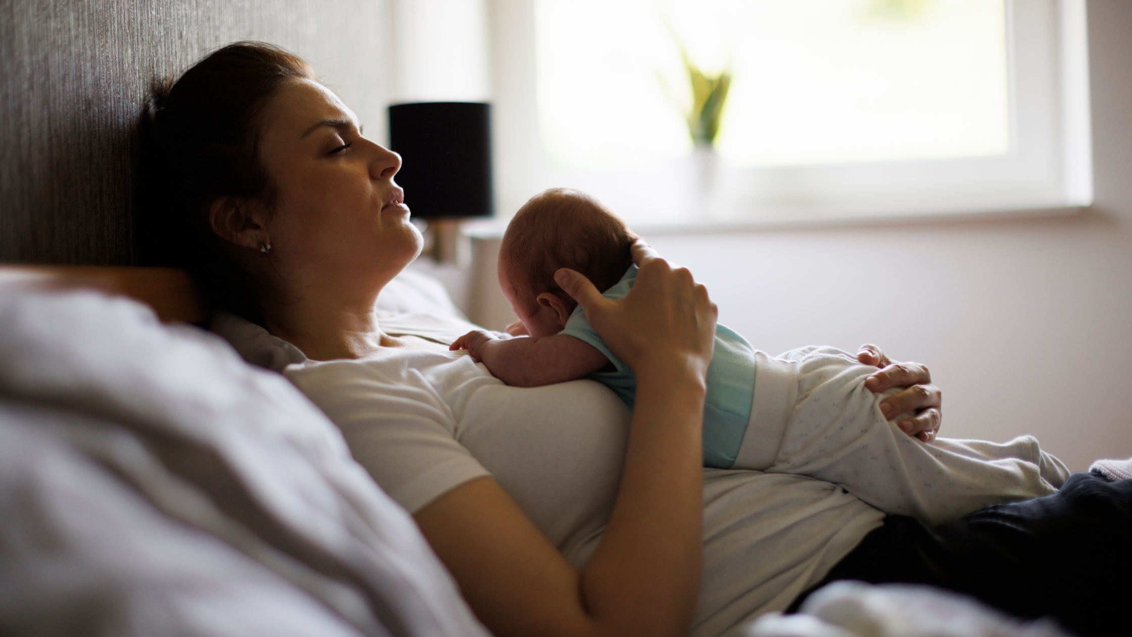 Photo of mom and newborn baby resting